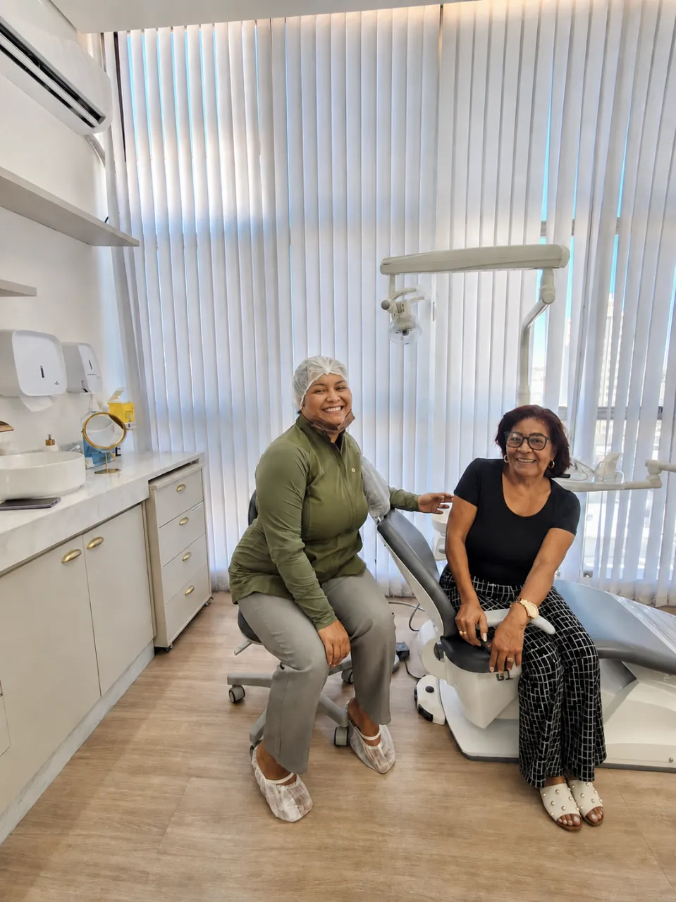 Dra. Juliana Laia ao lado de paciente sorridente após a consulta